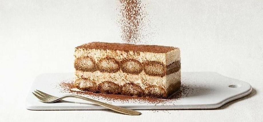 Elegant tiramisu dessert with visible layers and cocoa dusting